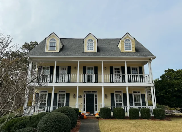 Before siding, window, porch column, deck, waterproofing, and exterior paint project in Marietta